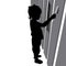 Vector silhouette of a cute five year old child, boy standing sideways, face in profile. A little boy paints with a paint brush on
