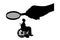 Vector silhouette employer`s hand looks through the magnifying glass to an invalid in a wheelchair waiting for an interview for w