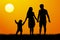 Vector silhouette of a family at sunset. Man woman child at dawn