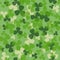 Vector St Patrick\'s day seamless pattern. Green and white clover leaves on green background