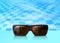 Vector summertime blue water pool with sunglasses