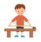 Vector working boy. Flat funny kid character doing measurements with tape-measure on work bench.