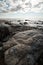 Veczemju Klintis - Boulder beach in Baltic country Latvia in April 2019 - Cloudy sky with dull clouds and a bit of sun