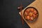 Veg Manchurian Gravy Balls in black bowl in dark slate table top. Vegetarian Manchurian is indian chinese cuisine dish