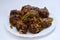 Veg Manchurian with gravy - Popular food of India made of cauliflower florets and other vegetable with white background