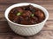 Veg Manchurian, Popular indo-chinese food made of cauliflower florets and other vegetable, served in a white plate over a rustic