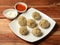 Veg steam momo. Nepalese Traditional dish Momo stuffed with vegetables and then cooked and served with sauce over a rustic wooden