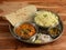 Veg Thali from an indian cuisine, food platter consists variety of veggies, jeera rice, roti, dal makhani etc., selective focus