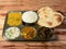 Veg Thali from an indian cuisine, food platter consists variety of veggies, lentils,Chole, steamed rice, roti, bindhi fry, curd,