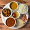 Veg Thali from an indian cuisine, food platter consists variety of veggies,paneer dish, lentils, jeera rice,roti, sweet dish,