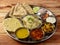 Veg Thali from an indian cuisine, food platter consists variety of veggies,paneer dish, lentils,rice,roti, sweet dish, snacks etc