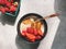 Vegan amaranth porridge with fried banana, fresh strawberries, almond milk