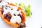 Vegan baked sweet potato filled with vegan cream, beans and mushrooms on white background