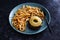 Vegan black bean burger with pineapple and gherkins topping and a side of french fries, healthy plant-based food