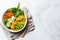 Vegan breakfast bowl - scrambled tofu, corn, beans, sweet potato and broccoli. Plant-based diet concept