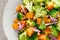 Vegan broccoli salad with baked pumpkin, red onion and walnuts