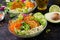 Vegan buddha bowl dinner food table. Healthy vegan lunch bowl. Fritter with lentils and radish, avocado, carrot salad.