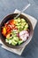 Vegan buddha bowl. Healthy vegetarian salad with cherry tomatoes, cucumber, radish,, avocado and lettuce