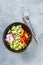 Vegan buddha bowl. Healthy vegetarian salad with cherry tomatoes, cucumber, radish,, avocado and lettuce