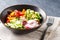 Vegan buddha bowl. Healthy vegetarian salad with cherry tomatoes, cucumber, radish,, avocado and lettuce