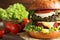 Vegan burger with beet and falafel patties on table against blurred background