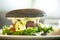 Vegan burger. Black bun, tofu-avocado salad, mayonnaise, cucumber, tomato, fresh salad. Delicious healthy hamburger food