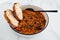 Vegan chilli sin carne with black beans and red lentils in spicy tomato sauce, healthy plant-based food