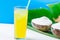 Vegan Coconut Ice Cream in Bowls on Large Green Palm Leaf Glass with Tropical Fruit Juice on White Marble Table Blue Background