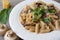 Vegan creamy mushroom garlic pasta garnished with basil