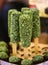 Vegan dessert candy with spirulina on stick on organic food market