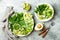 Vegan, detox Buddha bowl with avocado, zucchini noodles, green beans, spiralized cucumber, tomatoes, broccoli, lime and pesto