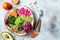 Vegan, detox Buddha bowl with quinoa, micro greens, avocado, blood orange, broccoli, watermelon radish, alfalfa seed sprouts.