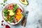 Vegan, detox Buddha bowl with turmeric roasted chickpeas, greens, avocado, persimmon, blood orange, nuts and pomegranate.