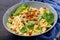 Vegan Farfalle pasta with spinach sauce with fried chickpeas.