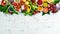 Vegan food banner. Fresh vegetables and fruits and berries on a white wooden background.