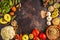 Vegan food ingredients on a dark background. Vegetables, fruits, cereals, nuts, beans top view.