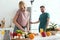 vegan girlfriend talking by smartphone while cooking salad