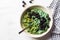 Vegan green oatmeal bowl with matcha tea, spirunina and blackberries. Healthy detox food concept