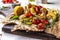 Vegan Grill menu, Grilled vegetables - zucchini, paprika, cherry tomatoes, corn, carrots and champignons served on wooden board at
