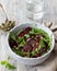 Vegan healthy beetroot salad with baked red onion, capers, watercress, greens and vinaigrette sauce