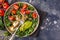 Vegan lentil meatballs salad with kale, avocado, tomato and tahini dressing.