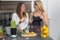 Vegan lesbian couple, preparing spinach smoothie. LGTB concept, vegan people