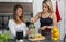 Vegan lesbian couple, preparing spinach smoothie. LGTB concept, vegan people