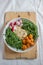 Vegan lunch bowl with quinoa, hummus, chickpeas, avocado