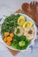 Vegan lunch bowl with quinoa, hummus, chickpeas, avocado, vegetables