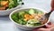 Vegan lunch - buddha bowl with zucchini pasta, grilled tofu, guacamole, sweet potato hummus and vegetables.