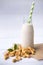 Vegan milk from cashews  in  bottles on  white wooden surface, Cashew nuts is used in most indian sweets with copy space,