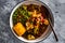 Vegan mixed vegetable roast with spicy broth, healthy plant-based food