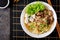 Vegan noodle soup with tofu cheese, shiitake mushrooms and lettuce