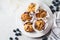 Vegan oatmeal, banana, blueberry muffins on gray background. Plant based dessert